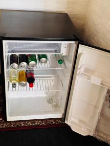 an open refrigerator filled with bottles and drinks at Posada Morotí in Esquina