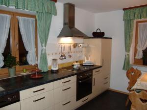 a kitchen with a sink and a stove at Haus Alpenglühn in Engedey