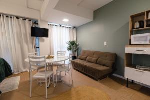 a living room with a couch and a table at P&G Apto 202-San Gimignano in Caxias do Sul