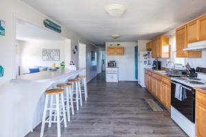 a kitchen with wooden cabinets and bar stools at 7847 - Summerset in Frisco