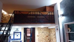 a loft bed in a house with a staircase at casa carmela in Bolognetta