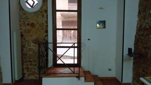 a room with a glass door with a window at casa carmela in Bolognetta