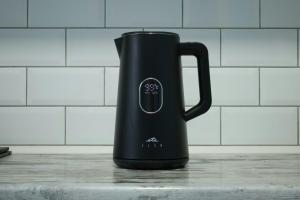 a black mug is sitting on a counter at Scarlett Near Cane River Falls in Bull Bay