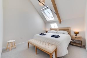 a bedroom with a bed with a bench and a skylight at 5 Bed in Croyde oc-croydb in Croyde