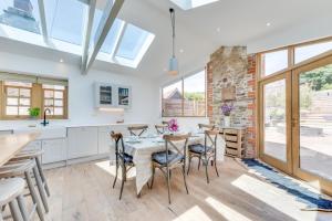 a kitchen and dining room with a table and chairs at 5 Bed in Croyde oc-croydb in Croyde