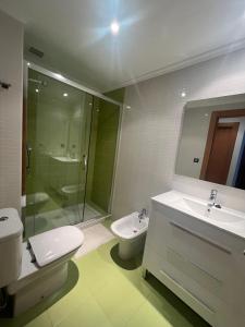 a bathroom with a toilet and a sink and a shower at El rincon del Cares in Panes
