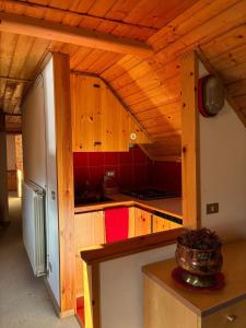 a kitchen with wooden cabinets and a refrigerator at La mansarda in Santa Maria Maggiore +10 photos