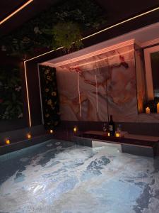 a jacuzzi tub with a painting on the wall at Rooms Vedran & AURUM Private Spa in Mostar