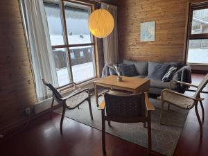 a living room with a couch and a table at Skutstuga 4 - Gruvbacken Huså in Järpen