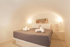 a bedroom with a bed with two white pillows at Arbarorisa Traditional Suites in Mesaria
