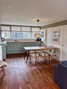 a kitchen and dining room with a wooden table at Beach Hangout Hygge in Den Burg