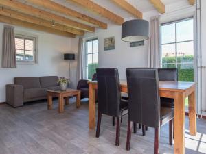 a dining room with a wooden table and chairs at Comfortable cottage with WiFi at 50 m from the Oosterschelde in Wemeldinge