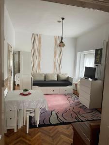 a living room with a couch and a table at Dombi Porta in Erdőbénye