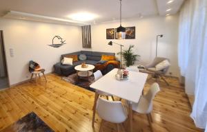 a living room with a couch and a table at TARNO Lake Apartment in Tarnobrzeg