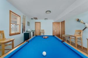 a blue pool table in a living room with at 7677 - Weathering Heights in Avon