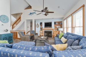 a living room with blue couches and a fireplace at 7677 - Weathering Heights in Avon +38 photos