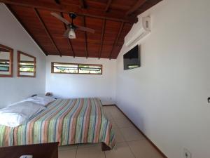a bedroom with a bed and a ceiling fan at Buzios Casa n#1 in Búzios +13 photos