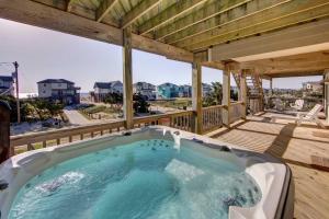 a hot tub on the deck of a house at 7678 - Drumstick in Avon