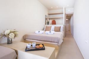 a hotel room with two beds and a tray of food at Charaki Rest Point in Haraki