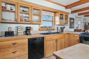 a kitchen with wooden cabinets and a black dishwasher at 7657 - Dragon's Lair in Avon