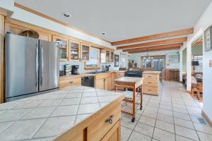 a large kitchen with wooden cabinets and a stainless steel refrigerator at 7657 - Dragon's Lair in Avon