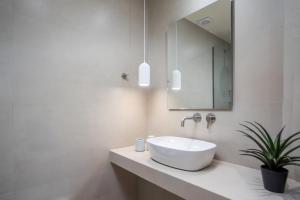 a bathroom with a white sink and a mirror at Charaki Rest Point in Haraki +23 photos
