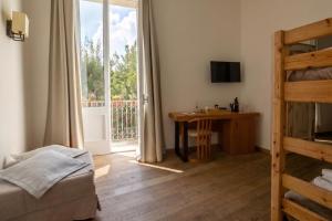 a bedroom with a bed and a desk and a window at B&B Il Palazzotto di Luca Luxury Suites in Lecce