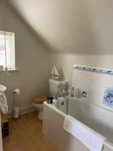a bathroom with a toilet and a bath tub at The Bird Loft Studio in Horsted Keynes +32 photos