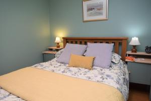 a bedroom with a bed with purple pillows at 2 Bed in Reef oc-r30133 in Uig