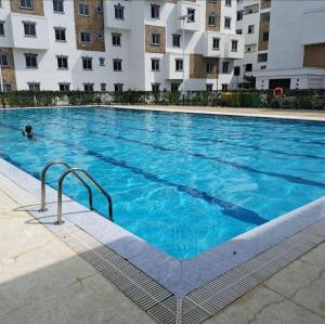 a large blue swimming pool in front of a building at SuCasa Homes in Mombasa