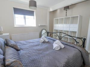 a bedroom with a bed with towels on it at Thorntons House in Northallerton