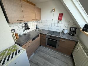 a small kitchen with a sink and a stove at FeWo Heaven in Winterberg