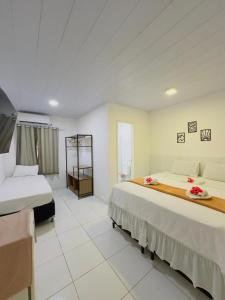 a large room with two beds and a room with at Pousada do Trinta in Fernando de Noronha