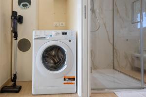 a washing machine in a bathroom with a shower at Sinarca Elysium Apartment in Termoli