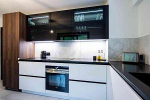 a kitchen with black and white cabinets and an oven at Tunisia la Goulette in Tunis