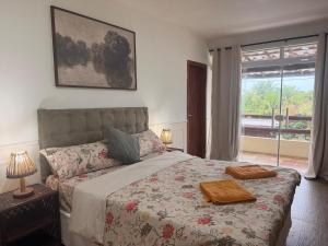 a bedroom with a large bed and a window at Villa Amarela in Itacimirim +59 photos