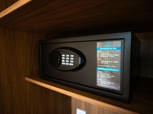 a small microwave sitting on a wooden shelf at Vektor Itabirito in Itabirito +7 photos