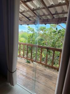 a view of a balcony from a room with a window at Villa Amarela in Itacimirim
