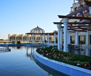a building with a river in front of a building at Anbar International Hotel in Kumaysh
