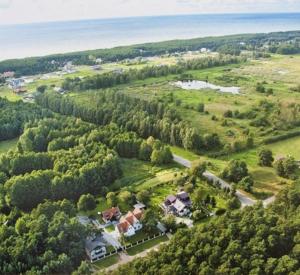 an aerial view of a house with trees and the ocean at Paliepgiris in Palanga
