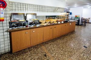 a buffet line in a restaurant with food at El Aram Beach Boa Viagem in Recife +32 photos