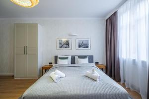 a bedroom with a bed with two pillows on it at Balans Studio Old Town I in Gdańsk