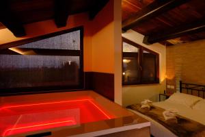 a bathroom with a bathtub with a red led lighting at La Maraviglia in Foligno