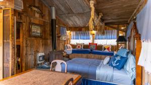 a bedroom with three beds and a table in it at Moon River Ranch in Satin