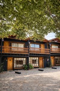 a large wooden house with a deck on it at Apart Hotel Blumenau in Osorno
