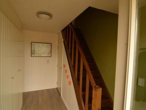a hallway with a staircase in a house at Modern Holiday Home with Private Garden in Tenneville