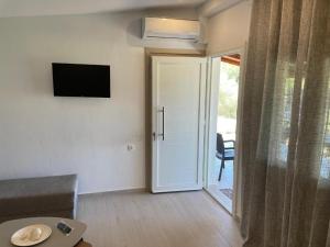 a living room with a door leading to a patio at Ktima Anna in Astris