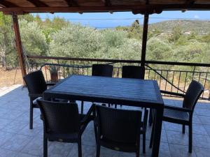 a blue table and chairs on a porch with a view at Ktima Anna in Astris