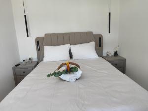 a bed with a flower arrangement on it at Ktima Anna in Astris