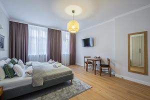 a bedroom with a bed and a table in it at Balans Studio Old Town I in Gdańsk